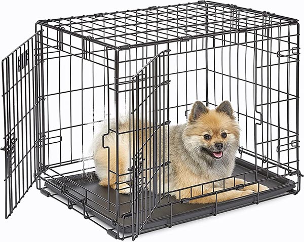 Photo of a MidWest Homes for Pets Single and Double Door Crate with a small dog sitting inside
