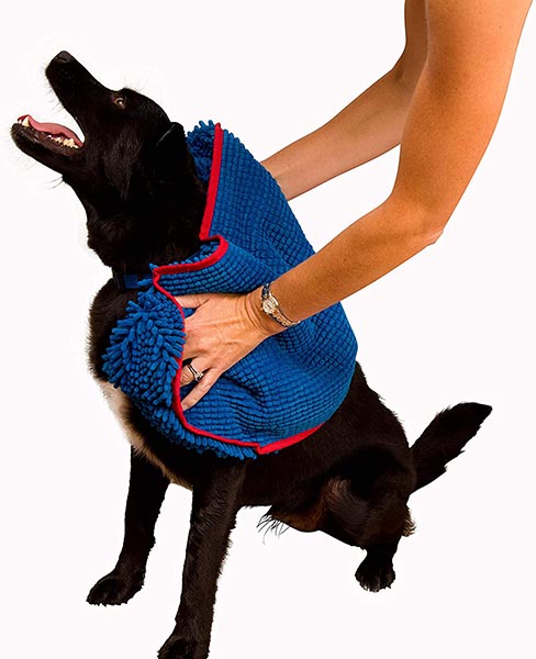 Photo of someone drying a dog off with a Soggy Doggy Super Shammy Dog Towel