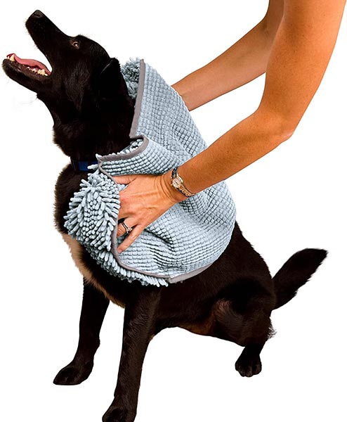 Photo of someone drying a dog off with a Soggy Doggy Super Shammy Dog Towel